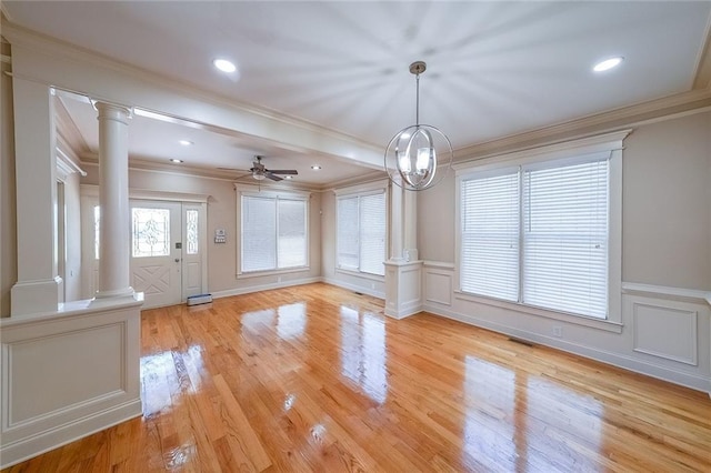3416 Harrison Rd, Atlanta, GA 30344 - unfurnished dining area with decorative columns, crown molding, a ceiling fan, light wood finished floors, and a decorative wall
