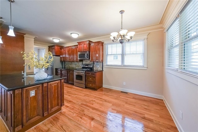 3416 Harrison Rd, Atlanta, GA 30344 - kitchen with stainless steel appliances, a chandelier, a sink, tasteful backsplash, and decorative light fixtures