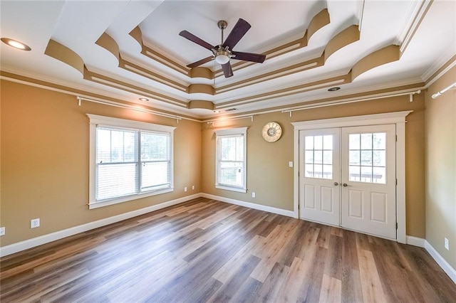 3416 Harrison Rd, Atlanta, GA 30344 - spare room featuring a tray ceiling, ornamental molding, a ceiling fan, wood finished floors, and baseboards