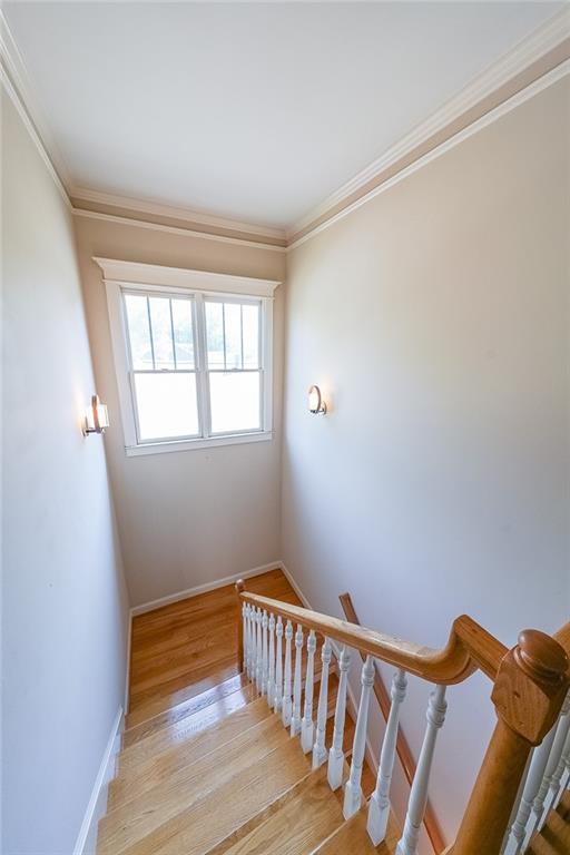 3416 Harrison Rd, Atlanta, GA 30344 - stairs featuring wood finished floors, baseboards, and crown molding