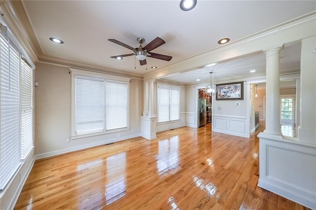 3416 Harrison Rd, Atlanta, GA 30344 - unfurnished room with decorative columns, crown molding, ceiling fan, a decorative wall, and light wood-style floors