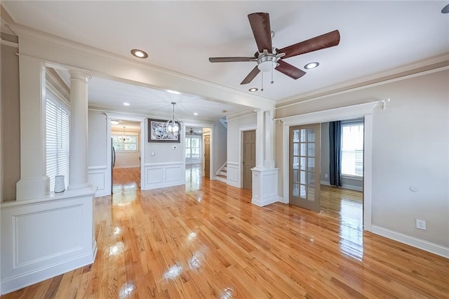 3416 Harrison Rd, Atlanta, GA 30344 - unfurnished living room with ornate columns, crown molding, a decorative wall, ceiling fan, and light wood-type flooring