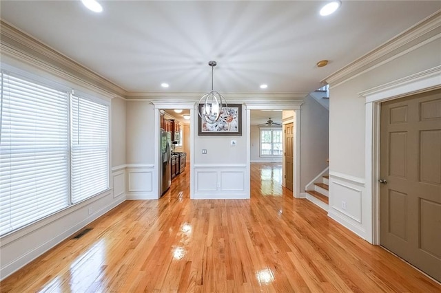 3416 Harrison Rd, Atlanta, GA 30344 - unfurnished dining area with a decorative wall, stairway, ornamental molding, light wood finished floors, and a wainscoted wall