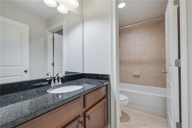 full bathroom with tile patterned floors, vanity, toilet, and tiled shower / bath combo