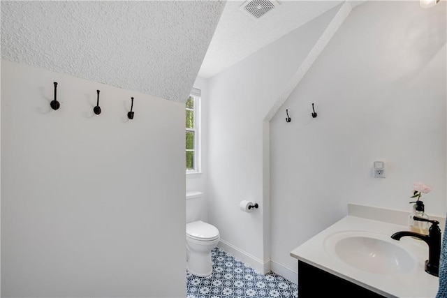 25 Deerhorn Dr, Jasper, GA 30143 - bathroom featuring toilet, a textured ceiling, vanity, baseboards, and vaulted ceiling