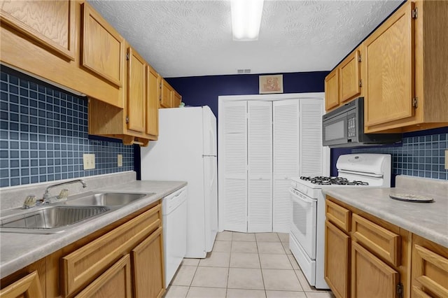 kitchen featuring tasteful backsplash, white appliances, sink, and light tile patterned floors