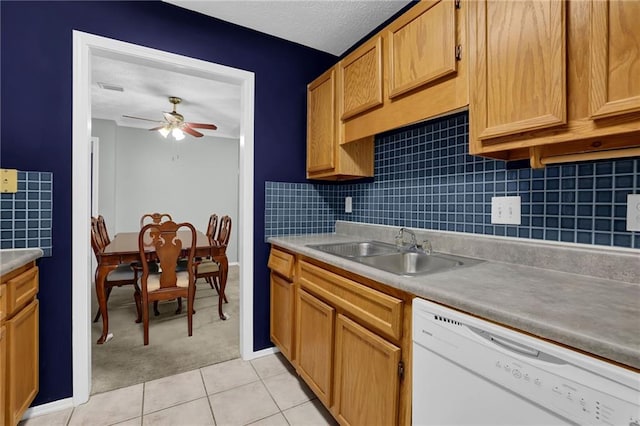 kitchen with sink, light tile patterned floors, dishwasher, ceiling fan, and tasteful backsplash