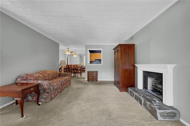 carpeted living room featuring crown molding, ceiling fan, and a textured ceiling