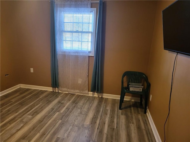 unfurnished room with hardwood / wood-style flooring