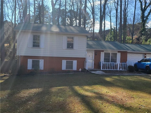 split level home featuring a porch, a front yard, and a garage