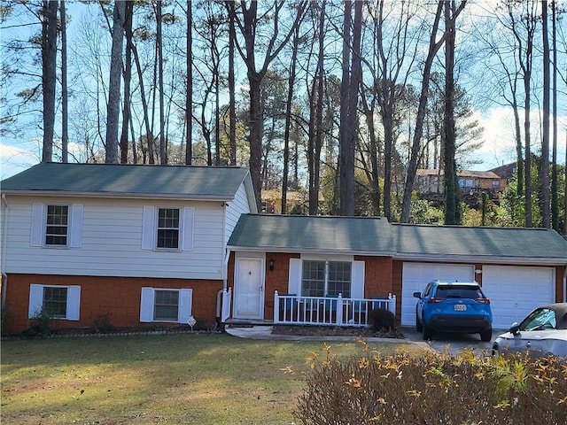 tri-level home featuring a porch, a garage, and a front yard