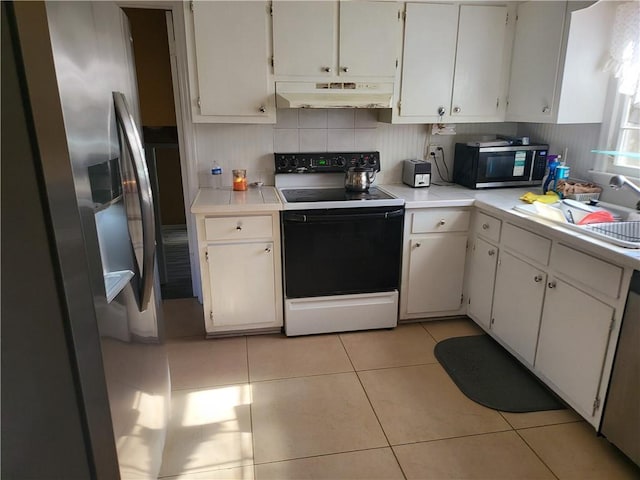 kitchen featuring white cabinets, light tile patterned floors, stainless steel appliances, and sink