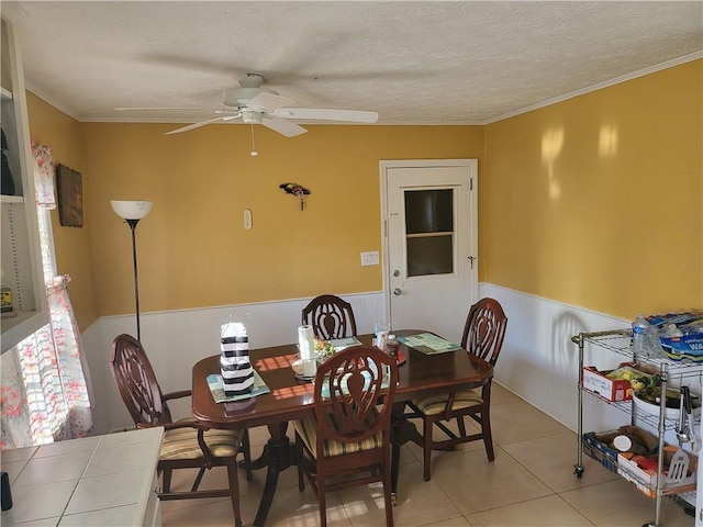 tiled dining area featuring ceiling fan and a textured ceiling