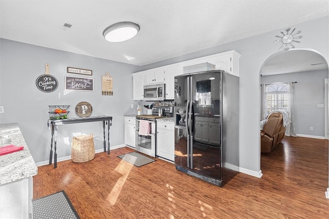 kitchen featuring wood-type flooring, white cabinetry, and stainless steel appliances