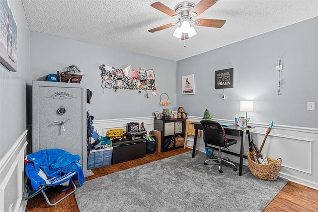 office featuring ceiling fan, dark hardwood / wood-style flooring, and a textured ceiling