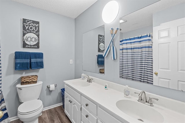 bathroom with a textured ceiling, vanity, a shower with curtain, toilet, and hardwood / wood-style flooring