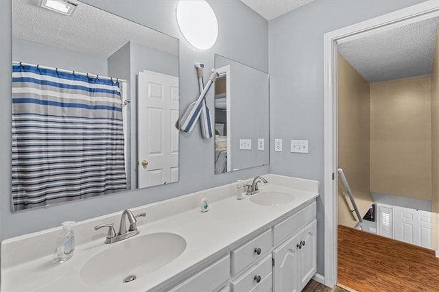 bathroom featuring a textured ceiling and vanity