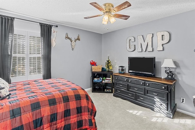 bedroom featuring a textured ceiling, ceiling fan, and carpet flooring