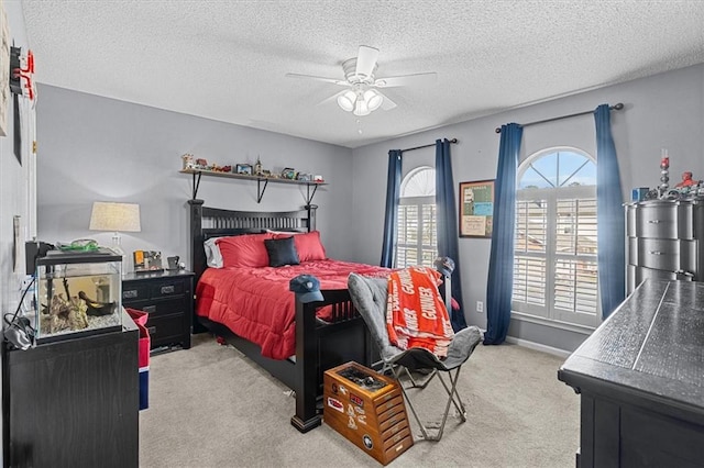 carpeted bedroom with a textured ceiling and ceiling fan