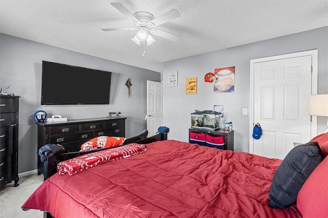 bedroom with a textured ceiling, ceiling fan, and light colored carpet