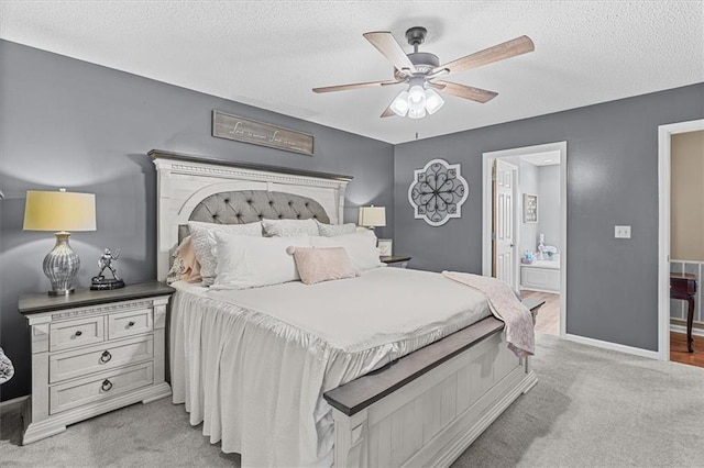 carpeted bedroom featuring ceiling fan and a textured ceiling