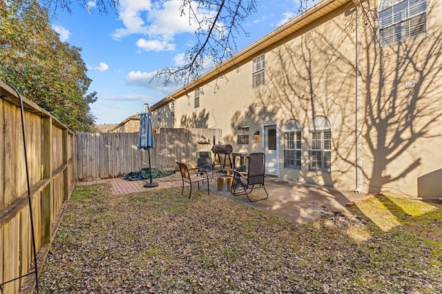 view of yard featuring a patio area and an outdoor fire pit