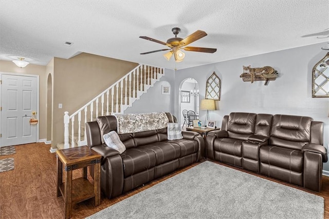 living room featuring a textured ceiling, ceiling fan, and hardwood / wood-style flooring