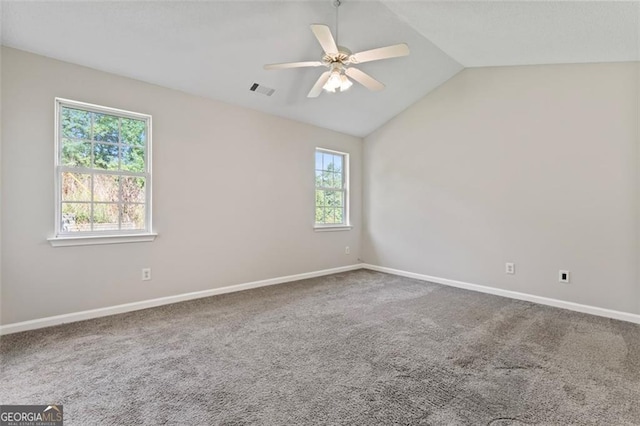 unfurnished room with visible vents, baseboards, ceiling fan, vaulted ceiling, and carpet flooring