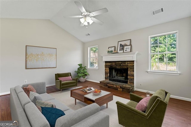 living room featuring a healthy amount of sunlight, visible vents, and wood finished floors