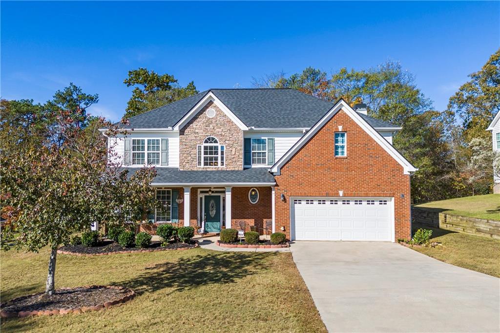 view of front of house featuring a garage and a front lawn