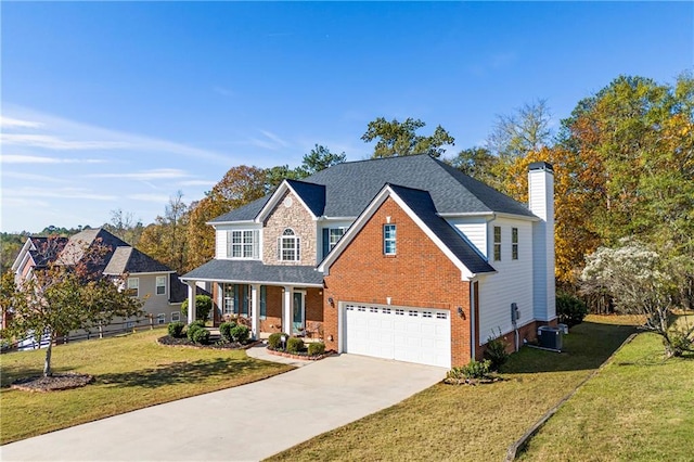 view of property with cooling unit, covered porch, a front yard, and a garage