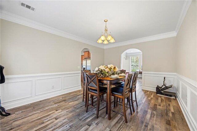 dining room featuring a chandelier, dark hardwood / wood-style floors, and crown molding