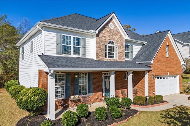 front of property featuring a porch and a garage