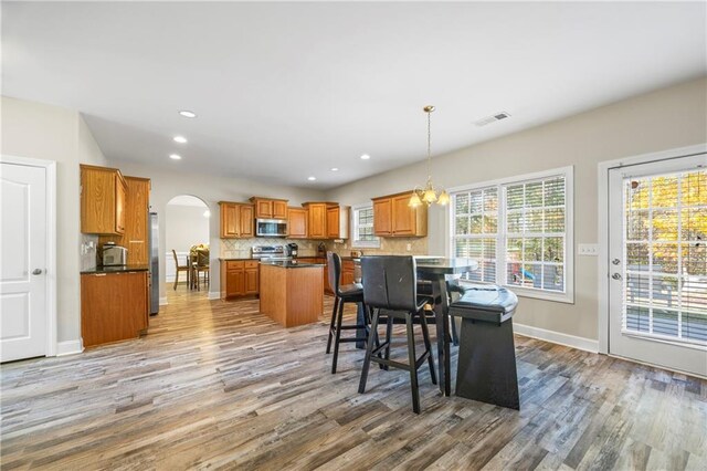 dining room featuring hardwood / wood-style flooring and a notable chandelier