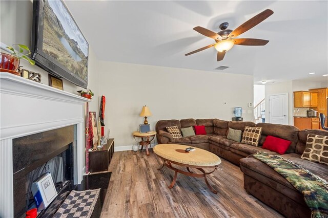 living room featuring ceiling fan and hardwood / wood-style floors