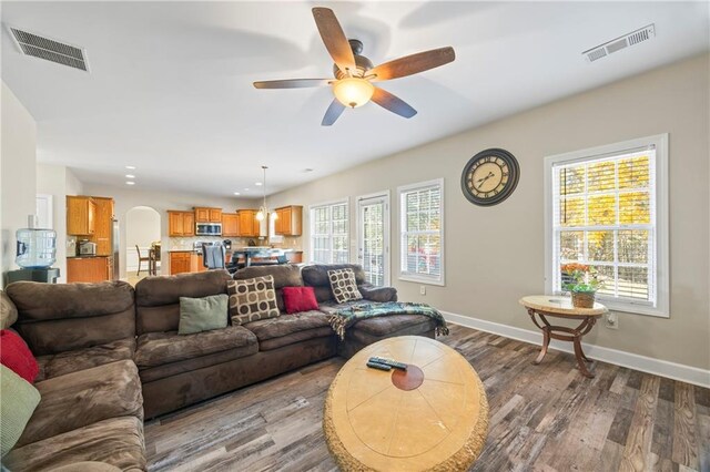 living room featuring ceiling fan and wood-type flooring