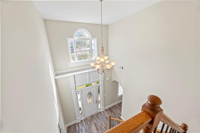 foyer featuring hardwood / wood-style flooring and a notable chandelier