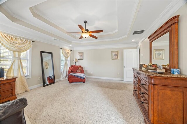 living area featuring ceiling fan, light colored carpet, crown molding, and a tray ceiling