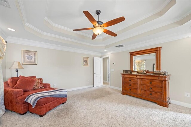 living area featuring light carpet, a tray ceiling, and crown molding