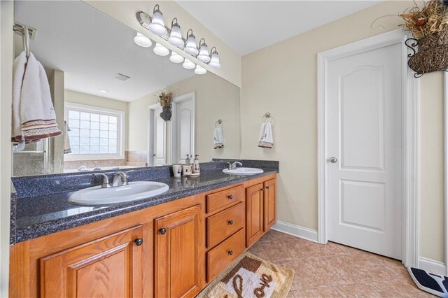 bathroom with tile patterned flooring and vanity