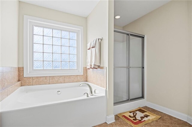 bathroom featuring tile patterned floors and independent shower and bath