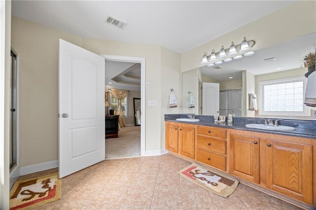 bathroom featuring tile patterned flooring, vanity, and an enclosed shower