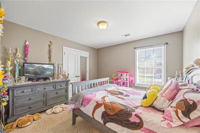 carpeted bedroom featuring a closet