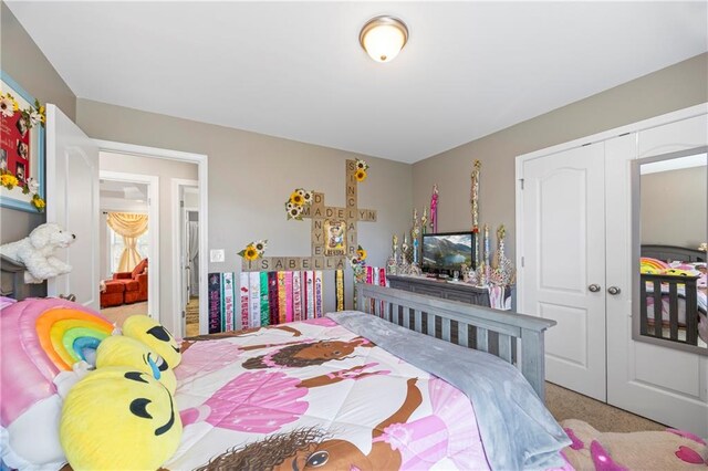 carpeted bedroom with a closet