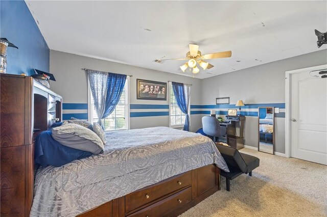 bedroom with ceiling fan and light carpet