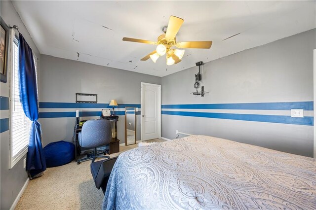 carpeted bedroom with multiple windows and ceiling fan