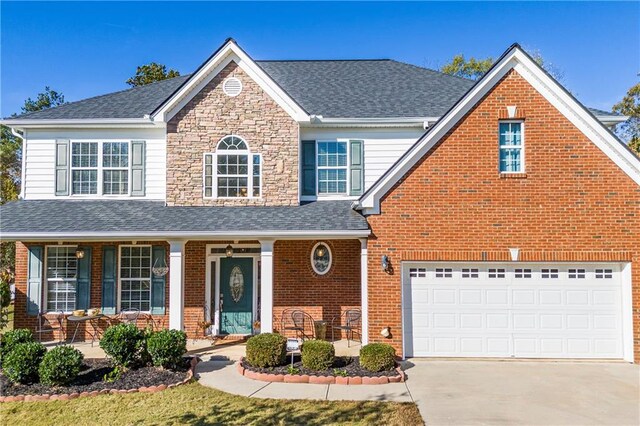 front of property featuring a garage and covered porch