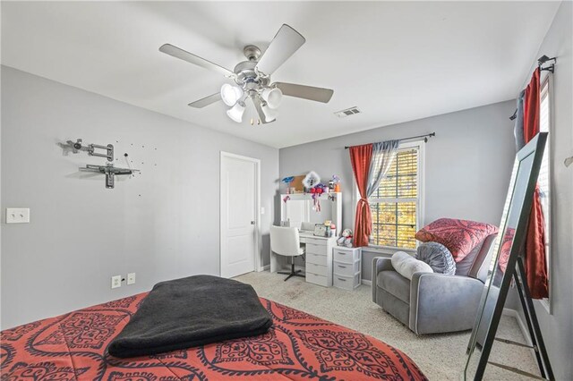 bedroom with ceiling fan and light carpet