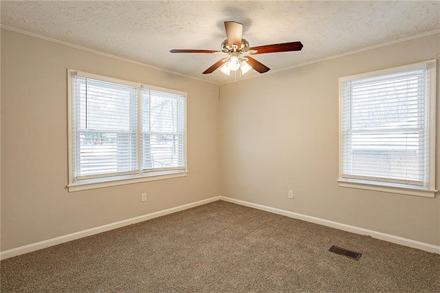 spare room with carpet flooring, a textured ceiling, ceiling fan, and ornamental molding