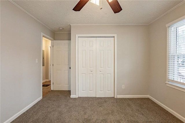 unfurnished bedroom featuring ceiling fan, a closet, carpet, and a textured ceiling